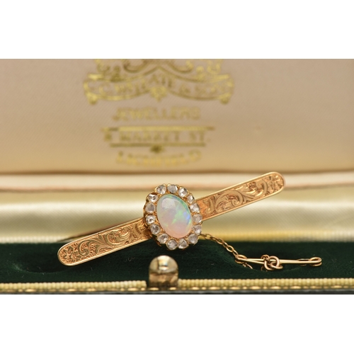 419 - A BOXED OPAL AND DIAMOND BAR BROOCH, designed as an oval cluster set with a central oval cut white o... 
