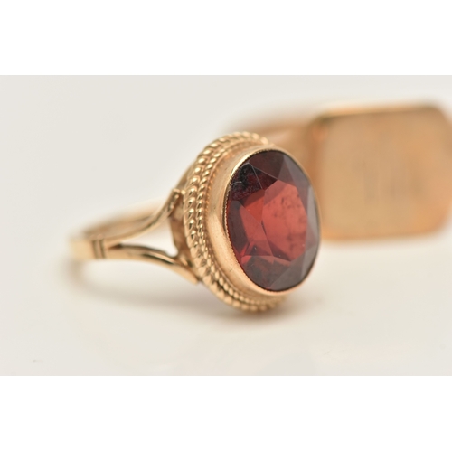 431 - TWO 9CT GOLD RINGS, the first set with an oval cut garnet, hallmarked 9ct Birmingham, ring size D 1/... 