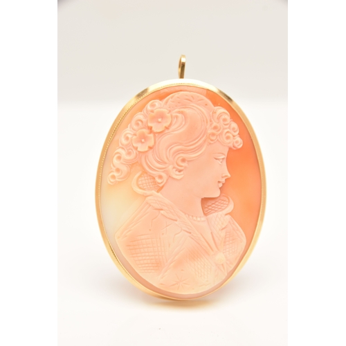 438 - A LARGE YELLOW METAL CAMEO BROOCH, carved shell cameo depicting a lady in profile, collet set with a... 