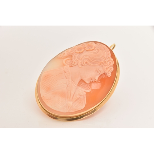 438 - A LARGE YELLOW METAL CAMEO BROOCH, carved shell cameo depicting a lady in profile, collet set with a... 
