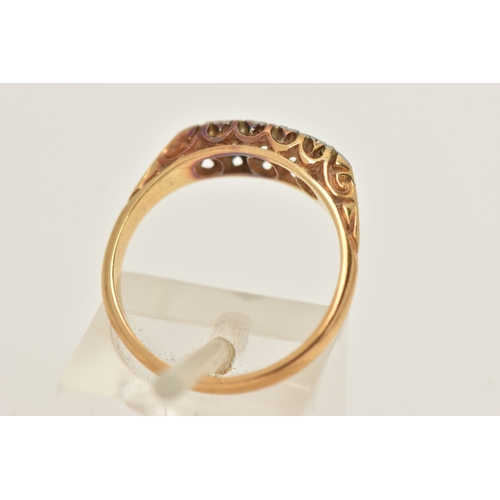 452 - A YELLOW METAL DIAMOND BOAT RING, one small round brilliant cut diamond and four single cut diamonds... 