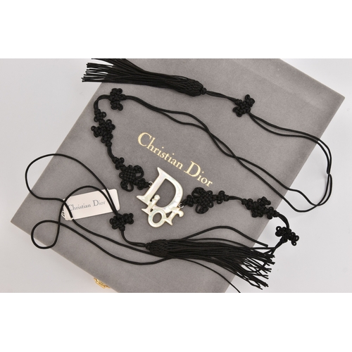 476 - A 'CHRISTIAN DIOR' BELT, a black cordette belt with oriental detail and tassel terminations, fitted ... 