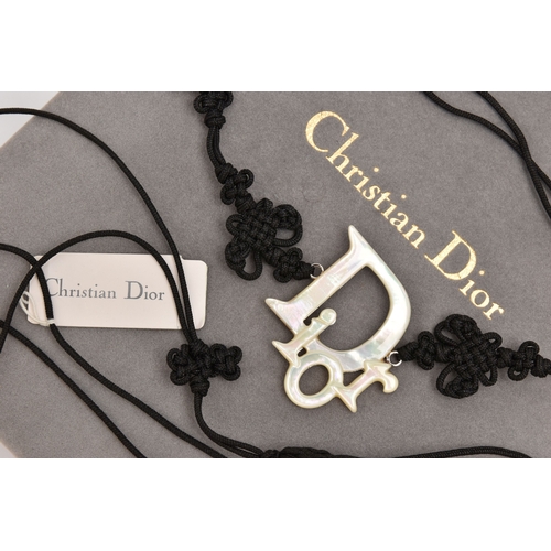 476 - A 'CHRISTIAN DIOR' BELT, a black cordette belt with oriental detail and tassel terminations, fitted ... 