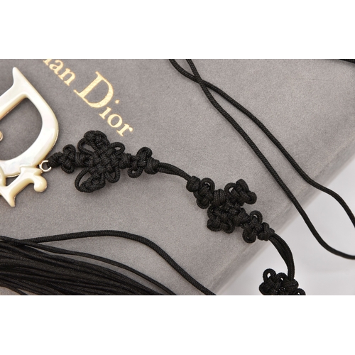 476 - A 'CHRISTIAN DIOR' BELT, a black cordette belt with oriental detail and tassel terminations, fitted ... 