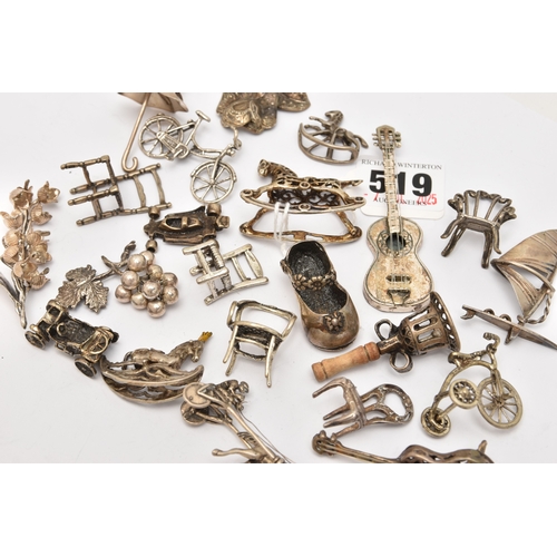 519 - AN ASSORTMENT OF WHITE METAL MINIATURE TRINKETS, to include rocking horses, umbrella, guitar, chairs... 