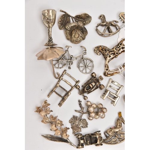 519 - AN ASSORTMENT OF WHITE METAL MINIATURE TRINKETS, to include rocking horses, umbrella, guitar, chairs... 