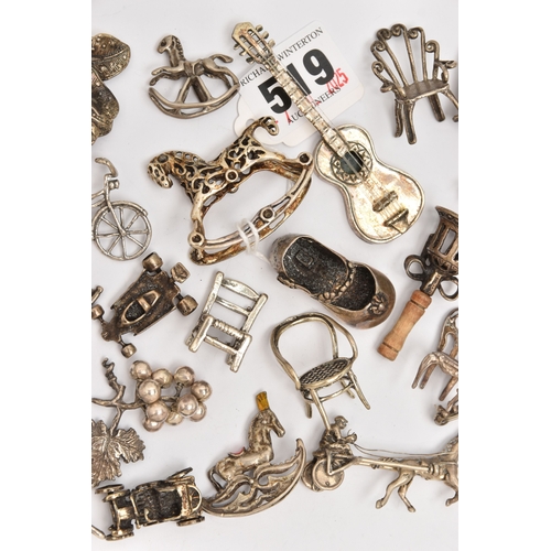 519 - AN ASSORTMENT OF WHITE METAL MINIATURE TRINKETS, to include rocking horses, umbrella, guitar, chairs... 