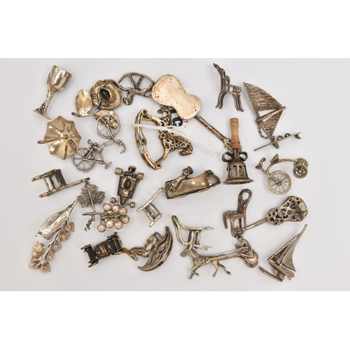 519 - AN ASSORTMENT OF WHITE METAL MINIATURE TRINKETS, to include rocking horses, umbrella, guitar, chairs... 