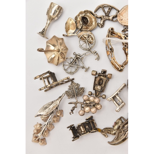519 - AN ASSORTMENT OF WHITE METAL MINIATURE TRINKETS, to include rocking horses, umbrella, guitar, chairs... 