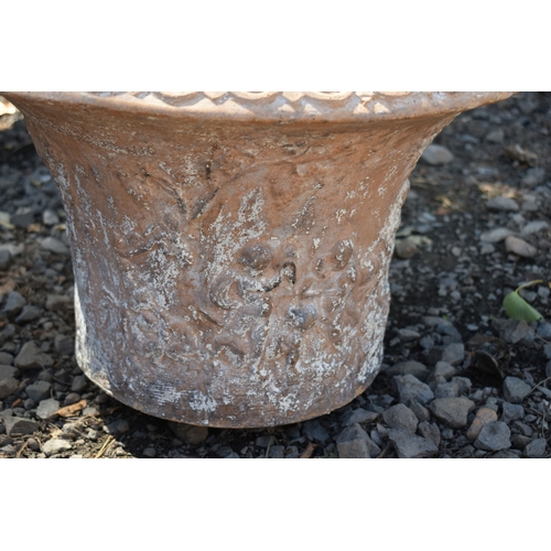 11 - A PAIR OF TERRACOTTA PLANT POTS, with a moulded design to the side, 45cm x height 33cm, condition re...