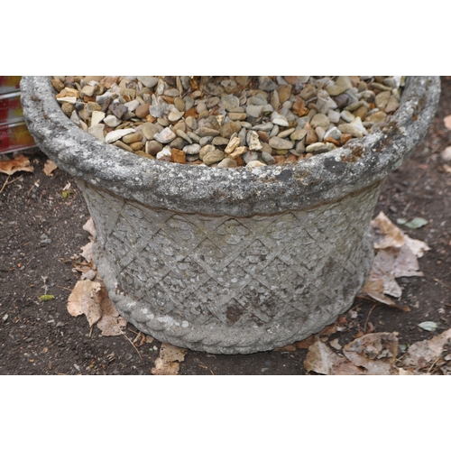 4 - A LARGE WEATHERED CONCRETE GARDEN PLANT POT with foliate motifs between lattice detailing, 60cm in d... 