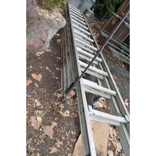 7 - AN ALUMINIUM TRIPLE EXTENSION LADDER with nine rungs to each 260cm length and a double extension lad... 