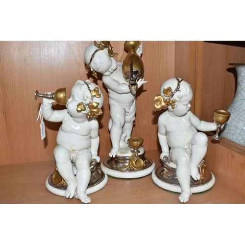 841 - THREE GIUSEPPE CALLÉ CAPODIMONTE FIGURES OF CHERUBS, the porcelain figures wearing gilt and silver l... 