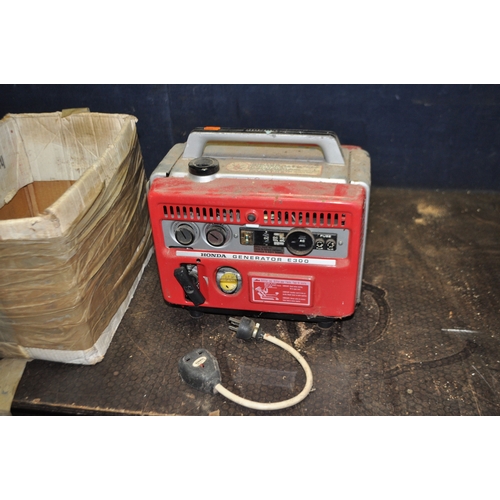 64 - A VINTAGE HONDA E300 PETROL GENERATOR, with a 3 pin euro plug socket, and 12v outlets, an adaptor fo... 
