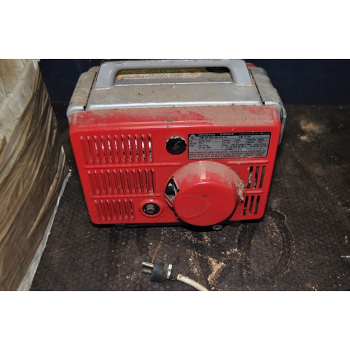 64 - A VINTAGE HONDA E300 PETROL GENERATOR, with a 3 pin euro plug socket, and 12v outlets, an adaptor fo... 