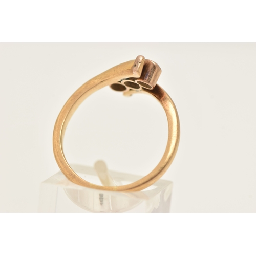 A YELLOW METAL THREE STONE DIAMOND RING, designed as three milgrain ...