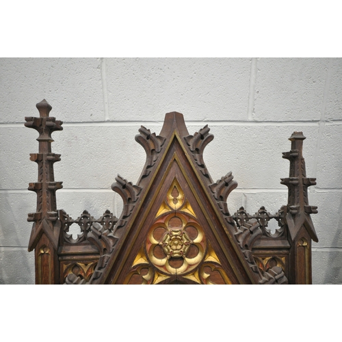A 20TH CENTURY OAK ECCLESIASTICAL REREDOS, with gilt details, carved ...