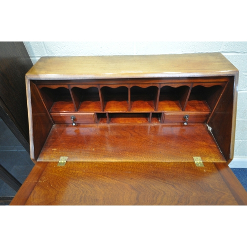 153 - A REPRODUCTION CHEST ON STAND, the fall front door enclosing a fitted interior, atop a base with fou... 