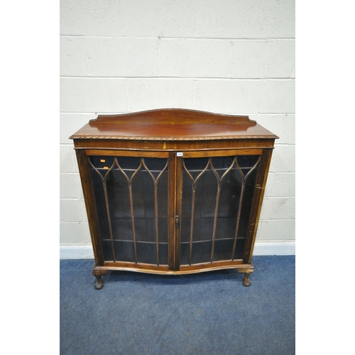 155 - AN EARLY 20TH CENTURY MAHOGANY SERPENTINE BOOKCASE, with a raised back, double glazed doors, raised ... 