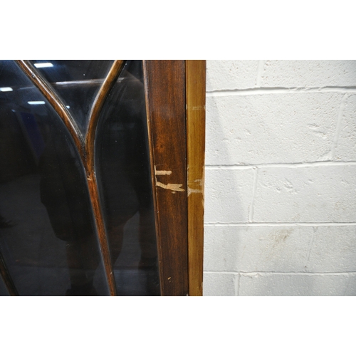 155 - AN EARLY 20TH CENTURY MAHOGANY SERPENTINE BOOKCASE, with a raised back, double glazed doors, raised ... 
