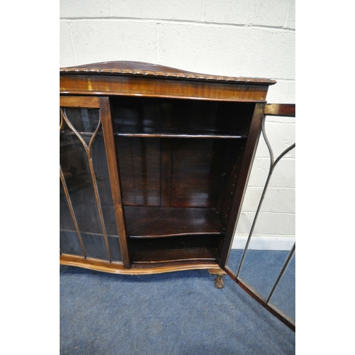 155 - AN EARLY 20TH CENTURY MAHOGANY SERPENTINE BOOKCASE, with a raised back, double glazed doors, raised ... 