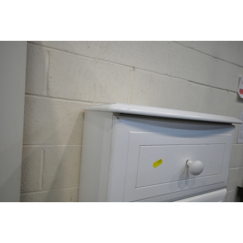 157 - A MODERN WHITE BEDROOM SUITE, comprising a triple door wardrobe, the central door with two rectangul... 
