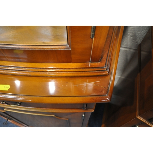 158 - A PAIR OF REPRODUCTION BOW FRONT YEW WOOD DISPLAY CABINETS, the double glazed doors enclosing a mirr... 