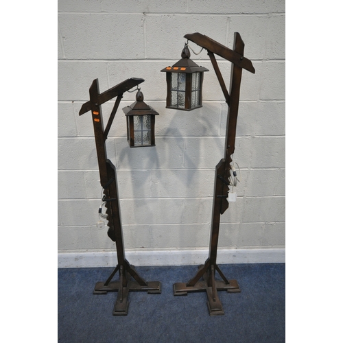 163 - A PAIR OF ARTS AND CRAFTS STYLE OAK STANDARD LAMP, with adjustable height clasp and a four sided gla... 