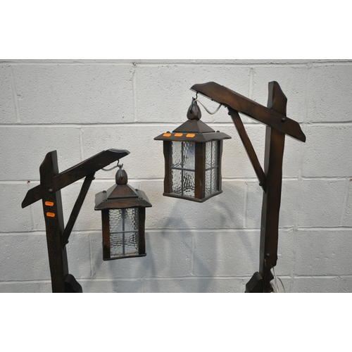 163 - A PAIR OF ARTS AND CRAFTS STYLE OAK STANDARD LAMP, with adjustable height clasp and a four sided gla... 
