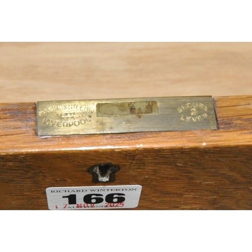 166 - WARING AND GILLOW, AN EARLY 20TH CENTURY OAK CABINET, with three drawers over double cupboard doors,... 