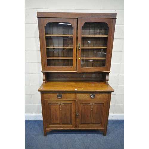 167 - AN ARTS AND CRAFTS OAK DRESSER, the double glass door enclosing three shelves, atop a base with two ... 