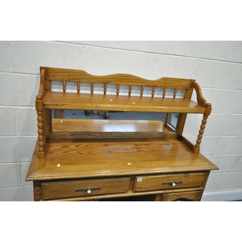 171 - AN OAK MIRROR BACK SIDEBOARD, with turned spindles and supports, two drawers over two lead glazed do... 
