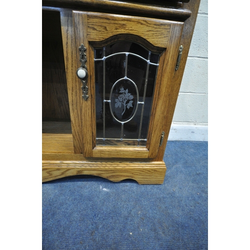 171 - AN OAK MIRROR BACK SIDEBOARD, with turned spindles and supports, two drawers over two lead glazed do... 