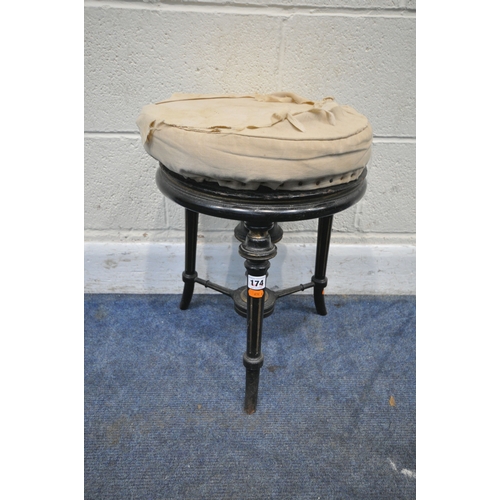 174 - A VICTORIAN EBONISED AND GILT PIANO STOOL, with a height adjustable spinning seat, raised on three l... 