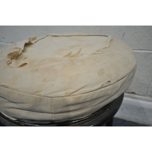 174 - A VICTORIAN EBONISED AND GILT PIANO STOOL, with a height adjustable spinning seat, raised on three l... 