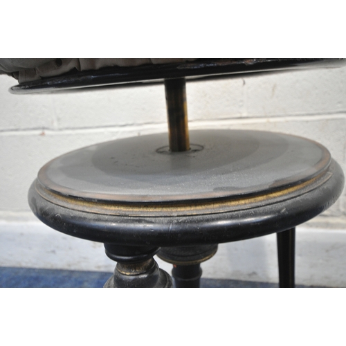 174 - A VICTORIAN EBONISED AND GILT PIANO STOOL, with a height adjustable spinning seat, raised on three l... 
