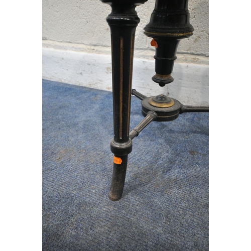 174 - A VICTORIAN EBONISED AND GILT PIANO STOOL, with a height adjustable spinning seat, raised on three l... 