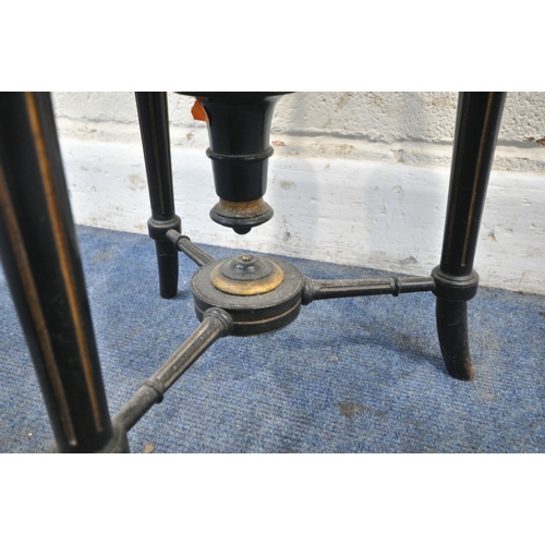 174 - A VICTORIAN EBONISED AND GILT PIANO STOOL, with a height adjustable spinning seat, raised on three l... 