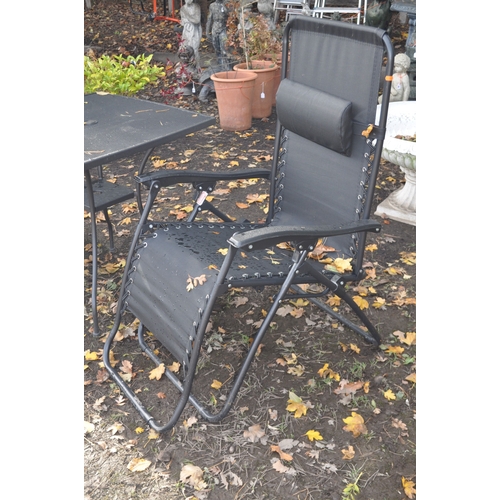 23 - A PAIR OF METAL FOLDING SUN LOUNGERS, and a metal garden table, 71cm x height 73cm (3)