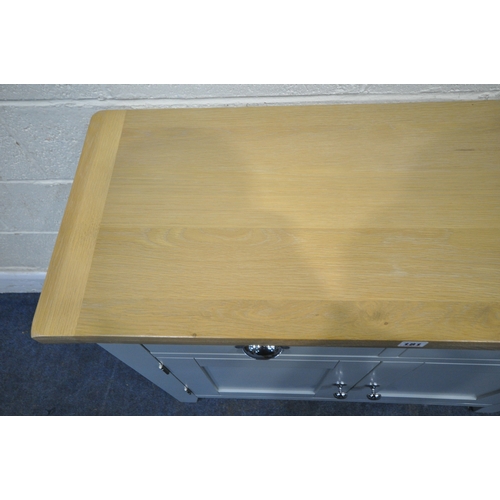 181 - A MODERN PARTIALLY PAINTED LIGHT OAK SIDE TABLE, with two drawers over double cupboard doors, width ... 