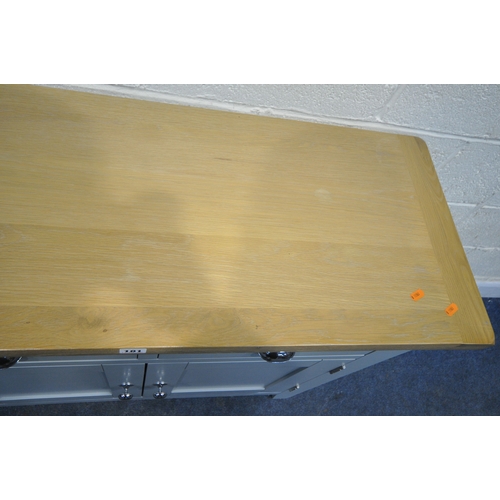 181 - A MODERN PARTIALLY PAINTED LIGHT OAK SIDE TABLE, with two drawers over double cupboard doors, width ... 