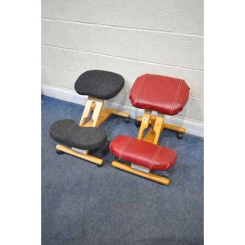 186 - A NEAR PAIR OF MODERN ERGONOMIC KNEELING CHAIRS, on castors, one with red leather upholstery, maximu... 