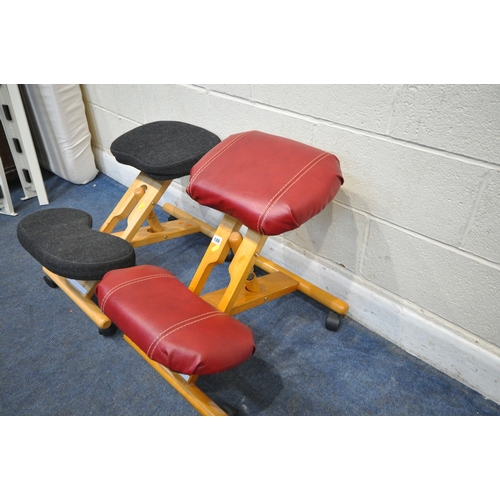 186 - A NEAR PAIR OF MODERN ERGONOMIC KNEELING CHAIRS, on castors, one with red leather upholstery, maximu... 