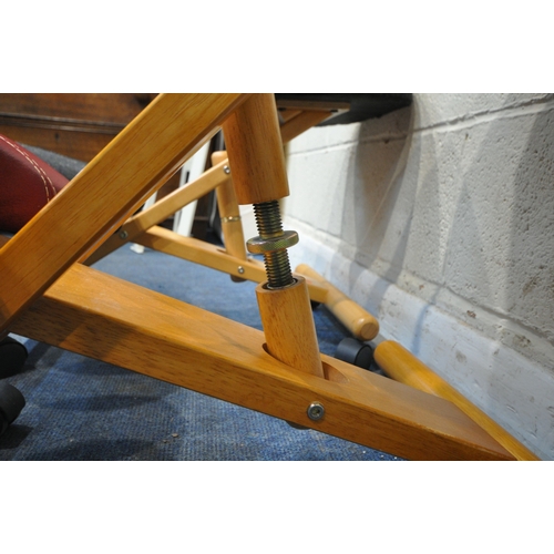 186 - A NEAR PAIR OF MODERN ERGONOMIC KNEELING CHAIRS, on castors, one with red leather upholstery, maximu... 