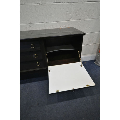 215 - A MID CENTURY SIDEBOARD, fitted with three drawers, double cupboard doors, and a fall front door, ra... 