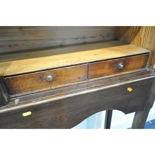 218 - AN OAK CABINET ON STAND, the double glass doors enclosing two shelves and four drawers, width 125cm ... 