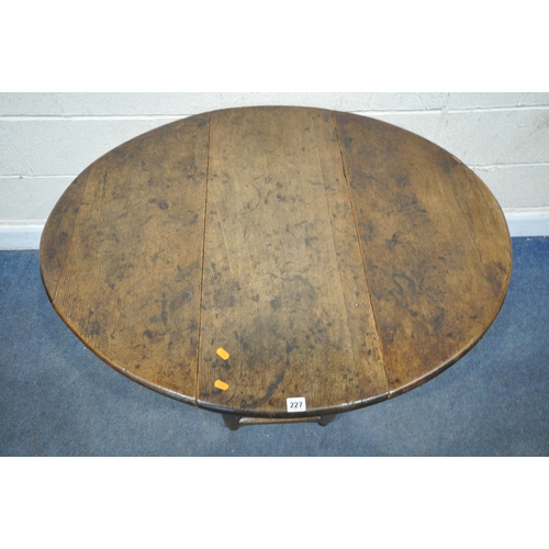 227 - A GEORGIAN OAK GATE LEG TABLE, raised on block and turned legs, open width 105cm x closed width 39cm... 