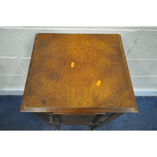 247 - A WALNUT POT CUPBOARD, with a single cupboard door, raised on square tapered legs with brass castors... 