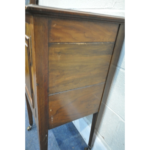247 - A WALNUT POT CUPBOARD, with a single cupboard door, raised on square tapered legs with brass castors... 