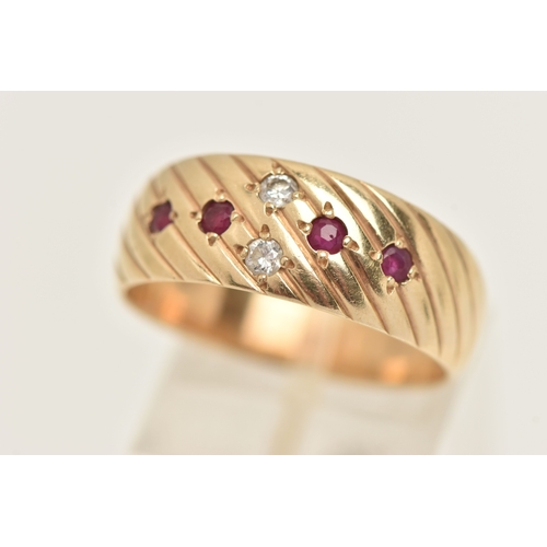 401 - A YELLOW METAL BAND RING, a yellow metal slightly tapered band ring with etched detail, flush set wi... 